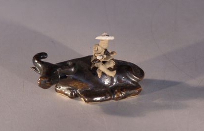 unknown Ceramic Figurine - Man Sitting on Water Buffalo<br>2.75 x 1.25 x 1.5